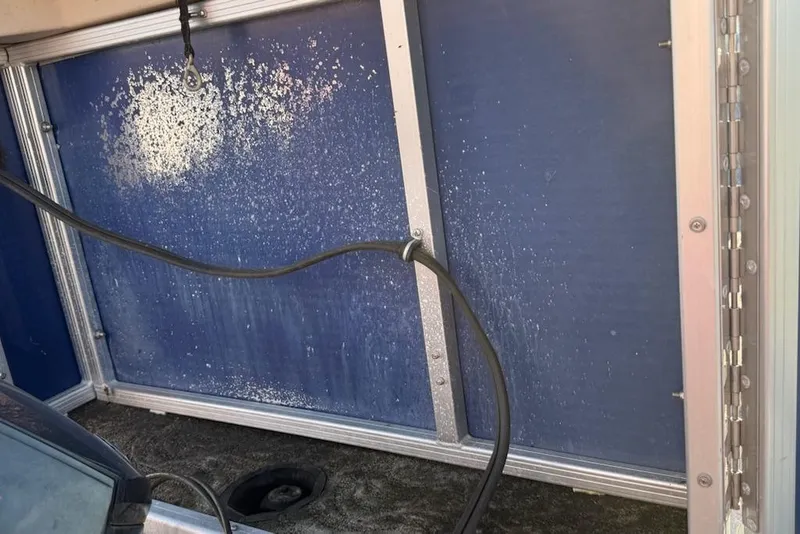 Slide: The Image of Interior view of a 2009 Sweetwater Tuscany Series 2086-23 boat, featuring a blue panel and cable. - 8