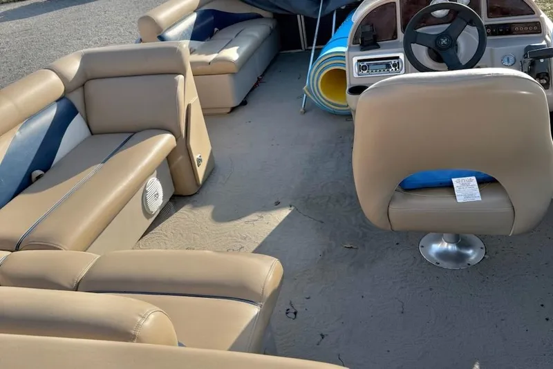 Slide: The Image of Interior of a 2009 Sweetwater Tuscany Series 2086-23 pontoon boat with beige seating. - 9