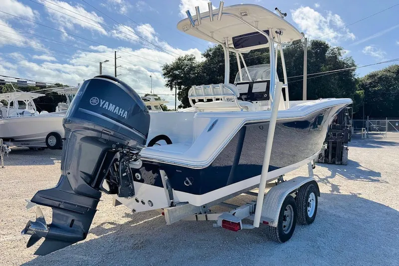 Slide: The Image of 2012 Tidewater 230 CC Adventure boat with Yamaha engine on trailer, sunny day. - 2