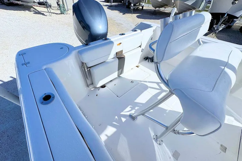 Slide: The Image of 2012 Tidewater 230 CC Adventure boat interior with seating and motor. - 5