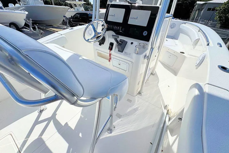 Slide: The Image of 2012 Tidewater 230 CC Adventure boat interior with steering console and seating. - 6