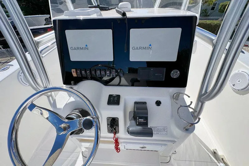 Slide: The Image of Console of 2012 Tidewater 230 CC Adventure boat with Garmin displays and steering wheel. - 7