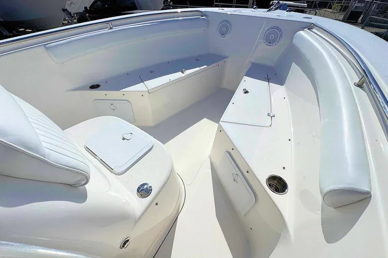 Slide: The Image of 2012 Tidewater 230 CC Adventure boat interior with white seating and storage compartments. - 9