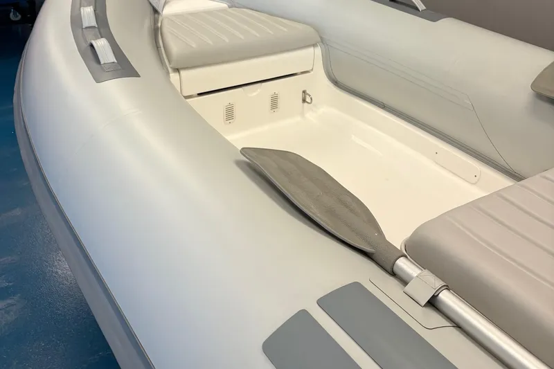 Slide: The Image of 2024 Flexboat F-12 inflatable dinghy displayed indoors with promotional signage. - 2