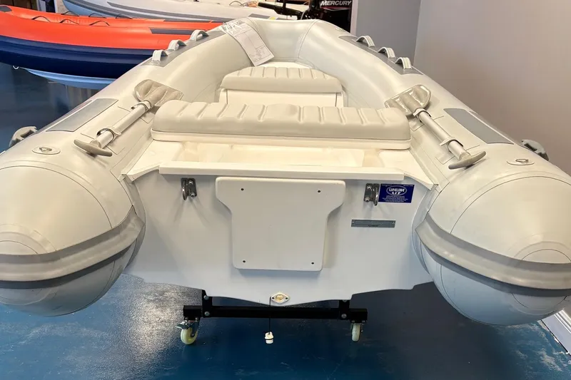 Slide: The Image of 2024 Flexboat F-12 inflatable boat displayed indoors with promotional signage. - 3