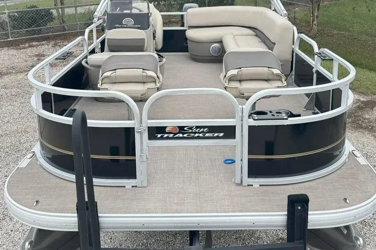 Slide: The Image of 2022 Sun Tracker Bass Buggy 16 XL pontoon boat with beige seating and black exterior. - 4
