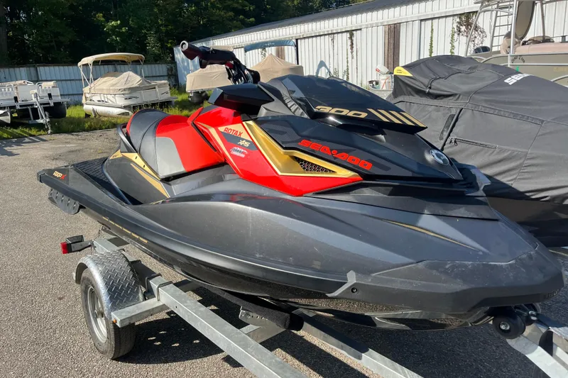 Slide: The Image of 2019 Sea-Doo RXP-X 300 jet ski on trailer, vibrant red and black design. - 4