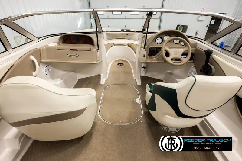Slide: The Image of 2003 Four Winns 180 Freedom I/O boat interior with steering wheel and seating. - 13