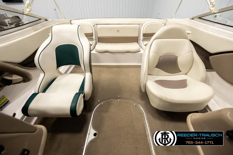Slide: The Image of Interior of 2003 Four Winns 180 Freedom I/O boat with beige and green seating. - 16