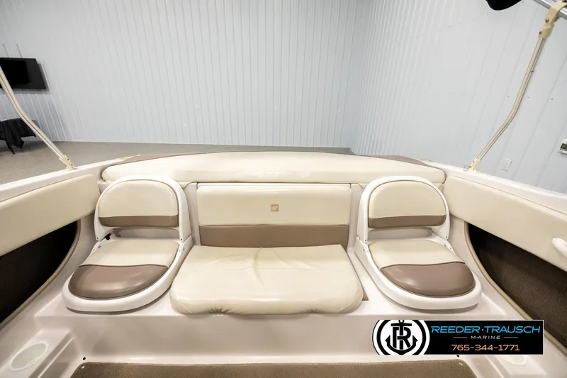 Slide: The Image of 2003 Four Winns 180 Freedom I/O boat interior with beige and brown seating. - 17