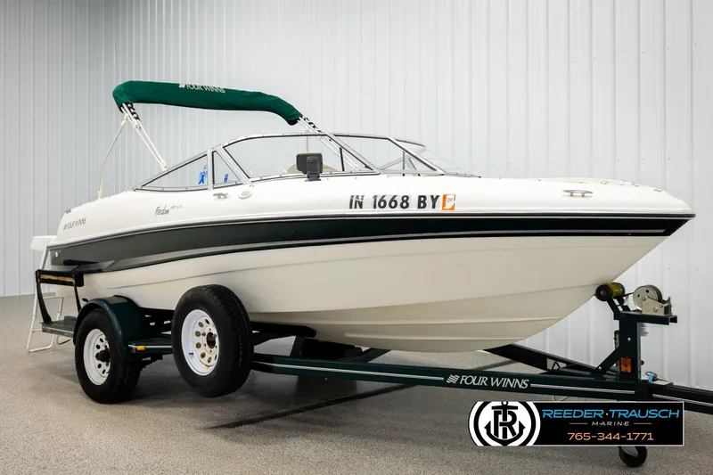 Slide: The Image of 2003 Four Winns 180 Freedom I/O boat on trailer in showroom. - 2