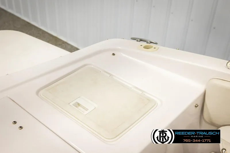 Slide: The Image of 2003 Four Winns 180 Freedom I/O boat interior detail with storage compartment. - 24