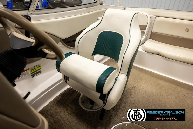 Slide: The Image of 2003 Four Winns 180 Freedom I/O boat interior with steering wheel and seating. - 26