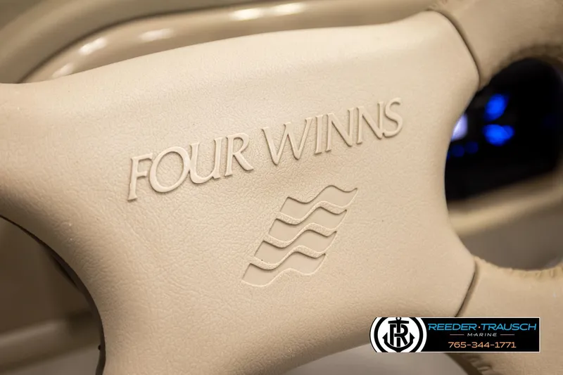 Slide: The Image of Steering wheel of 2003 Four Winns 180 Freedom I/O boat, featuring logo and branding. - 30