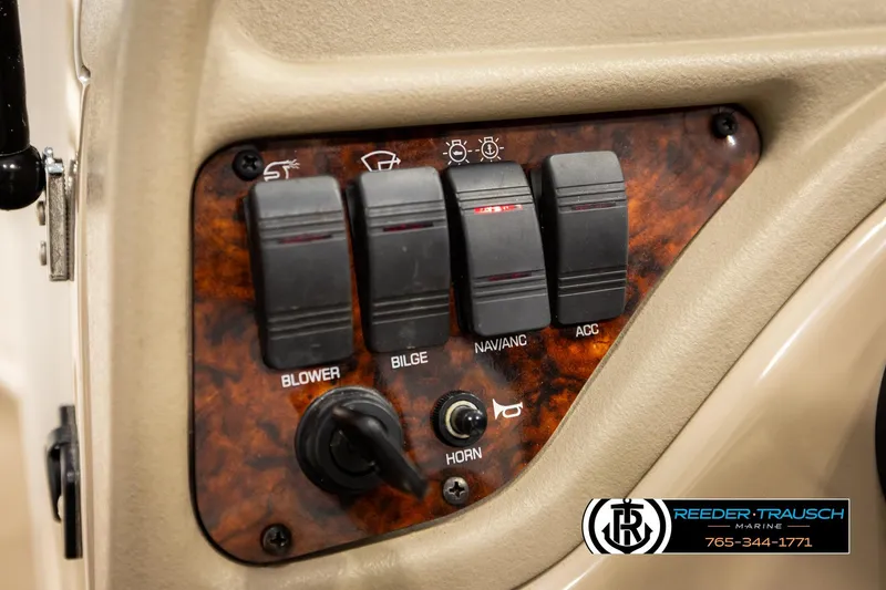 Slide: The Image of Control panel of a 2003 Four Winns 180 Freedom I/O boat with switches and horn button. - 31