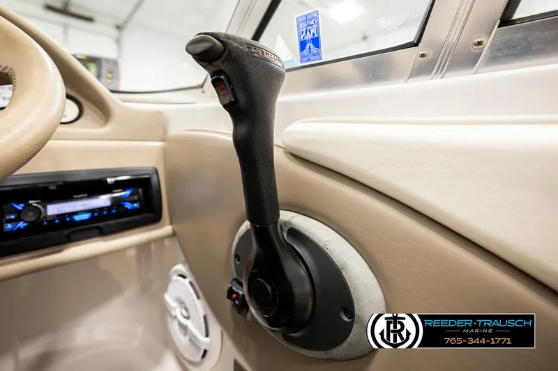 Slide: The Image of Interior of 2003 Four Winns 180 Freedom I/O boat with control lever and stereo system. - 34