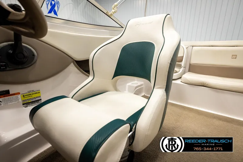 Slide: The Image of 2003 Four Winns 180 Freedom I/O boat interior with white and green seating. - 35