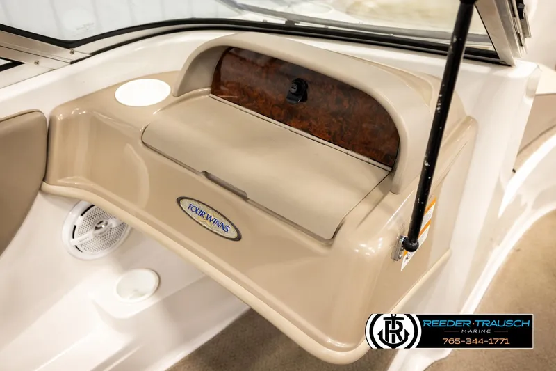 Slide: The Image of 2003 Four Winns 180 Freedom I/O boat dashboard with storage compartment and speaker. - 38