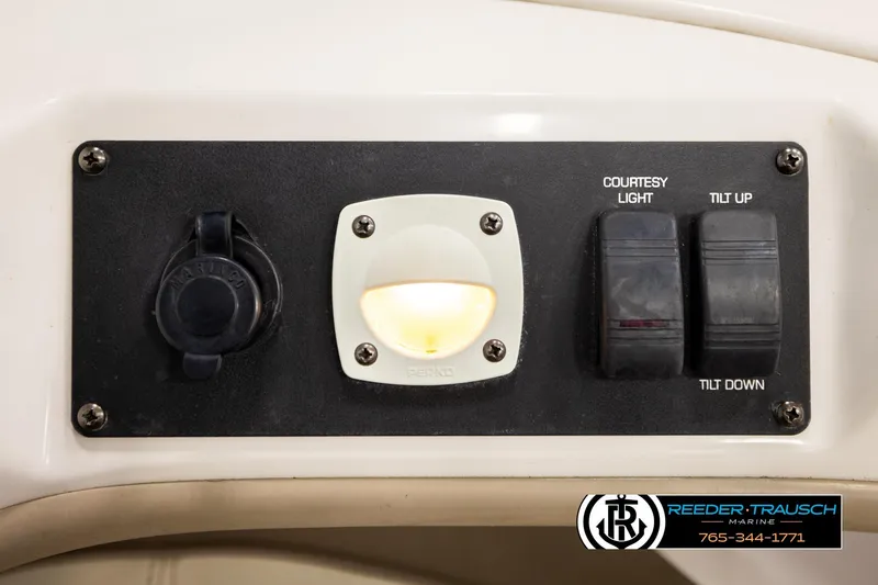 Slide: The Image of Control panel of a 2003 Four Winns 180 Freedom I/O boat with courtesy light and tilt switches. - 42