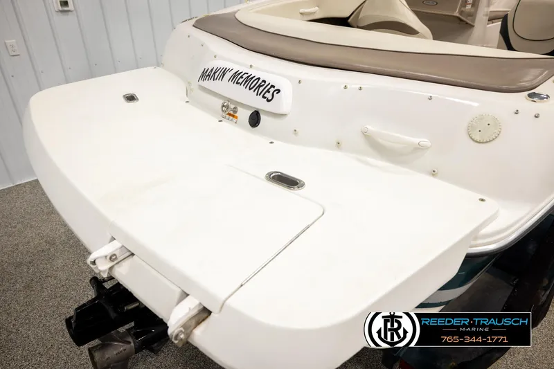 Slide: The Image of 2003 Four Winns 180 Freedom I/O boat, rear view, white deck, "Makin' Memories" text. - 43