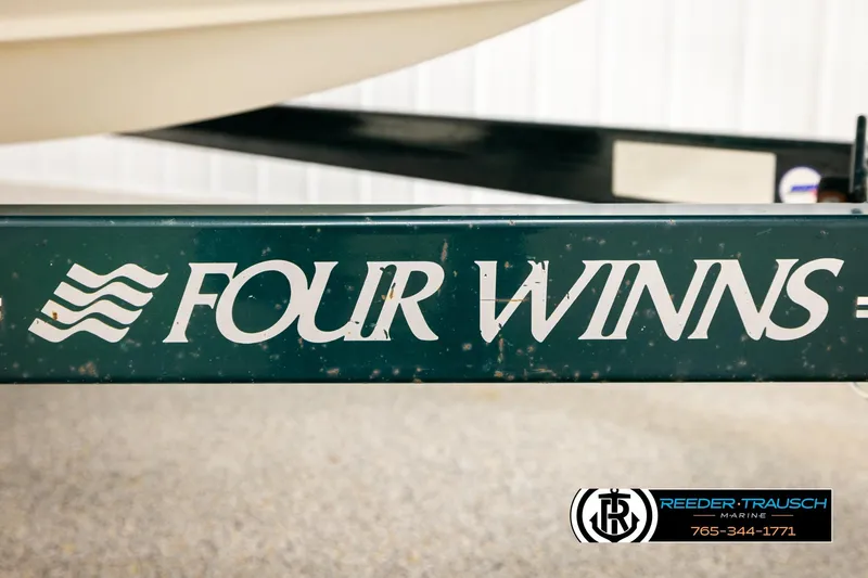 Slide: The Image of 2003 Four Winns 180 Freedom I/O boat trailer with logo and contact information. - 46