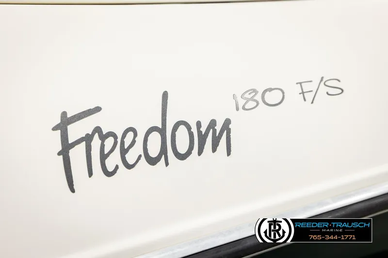 Slide: The Image of 2003 Four Winns 180 Freedom I/O boat logo with Reeder-Trausch Marine branding. - 49