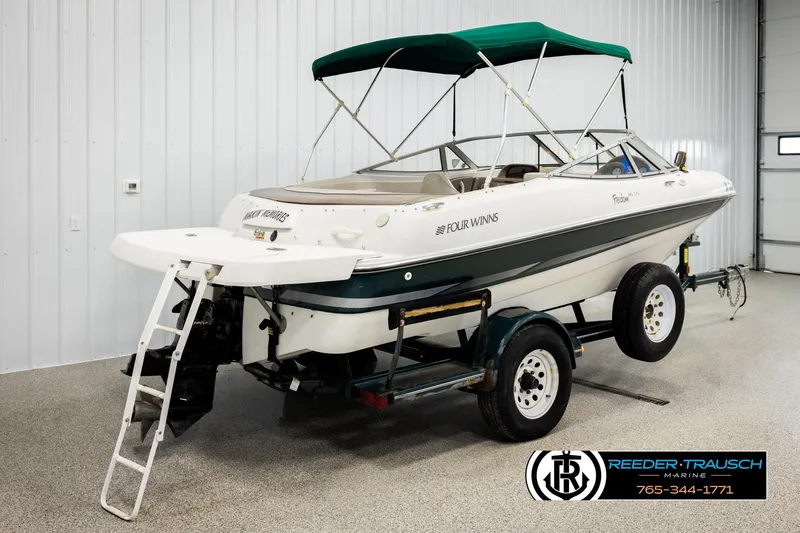 Slide: The Image of 2003 Four Winns 180 Freedom I/O boat on trailer in indoor showroom. - 5