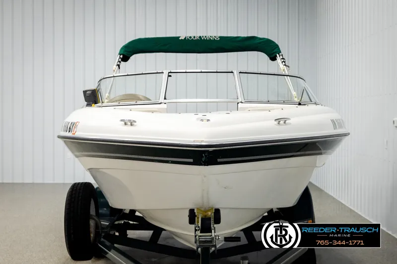 Slide: The Image of 2003 Four Winns 180 Freedom I/O boat on trailer in indoor storage. - 7