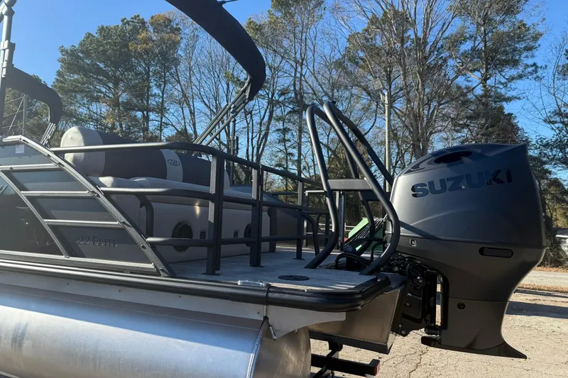 Slide: The Image of 2026 Bentley Pontoons Elite 223 with Suzuki engine, parked outdoors. - 4