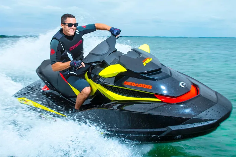 Slide: The Image of Manufacturer Provided Image: Man riding a 2015 Sea-Doo RXT 260 jet ski on the water. - 2