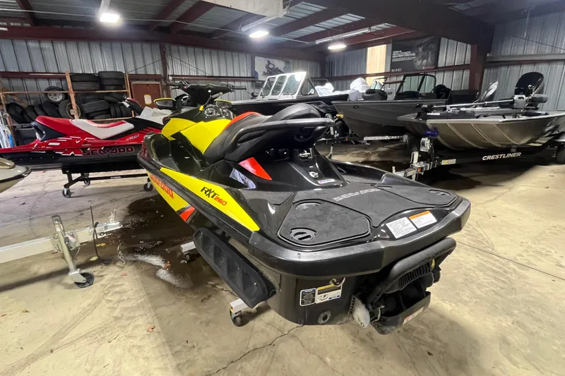 Slide: The Image of 2015 Sea-Doo RXT 260 jet ski in a storage facility with other boats. - 6