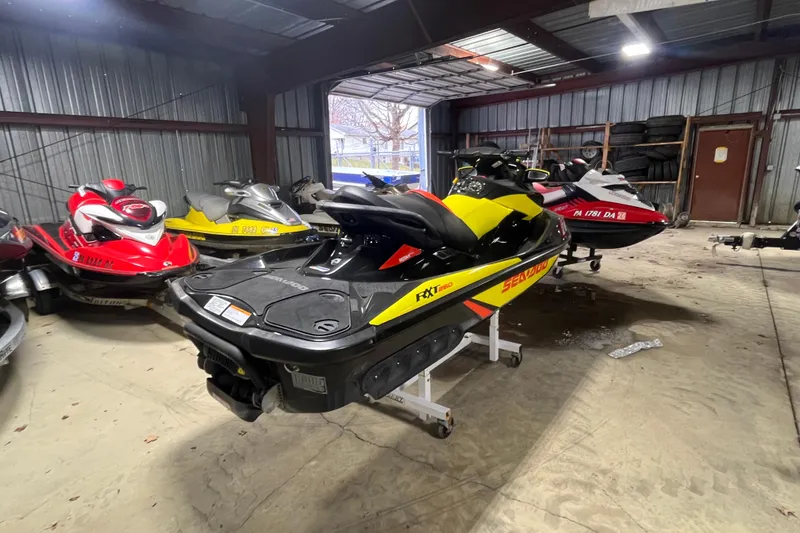 Slide: The Image of 2015 Sea-Doo RXT 260 jet ski in a storage facility with other watercraft. - 7