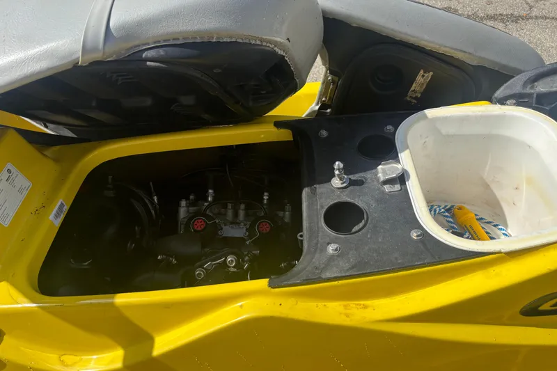 Slide: The Image of 2002 Sea-Doo GTX engine compartment with open storage area and visible components. - 7