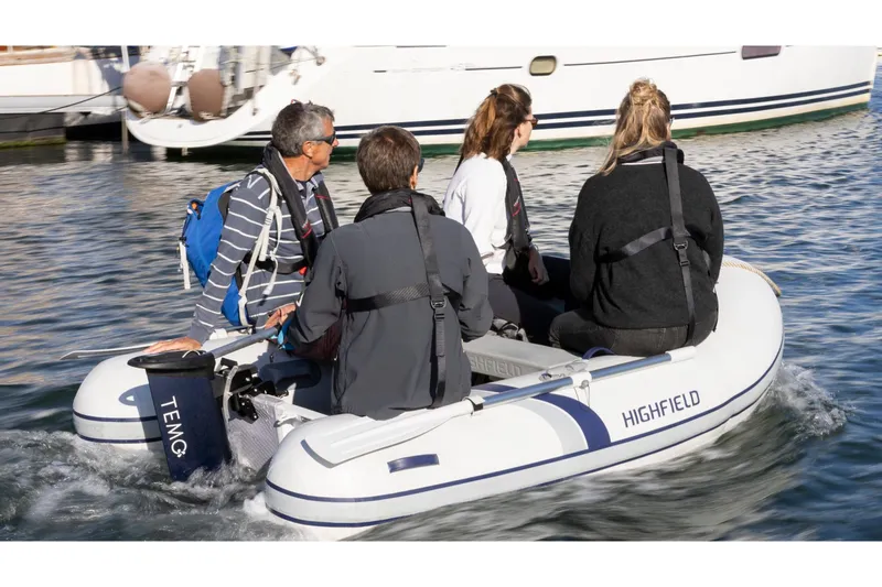 Slide: The Image of Four people in a Highfield Roll-Up 200 KAM inflatable boat. - 4