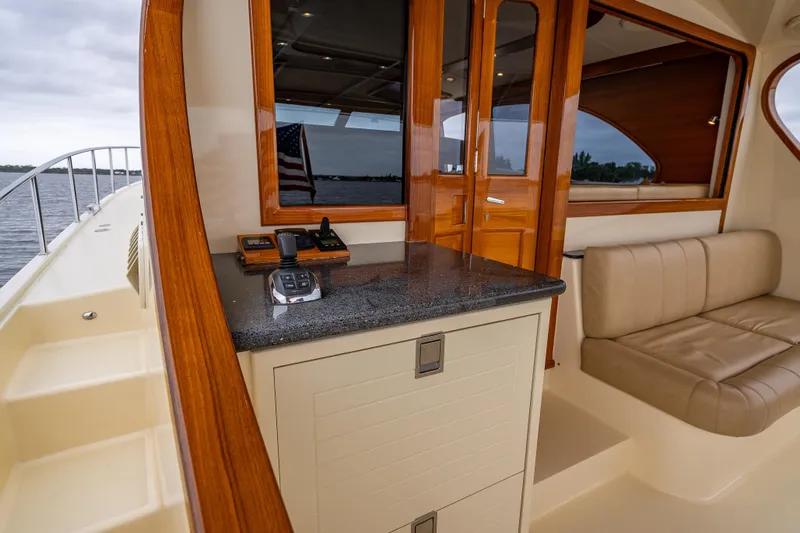 Slide: The Image of 2018 Palm Beach Motor Yachts PB55 interior with elegant wood finish and comfortable seating. - 14