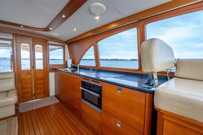 Slide: The Image of Luxurious interior of 2018 Palm Beach Motor Yachts PB55 with elegant wood finishes and scenic views. - 21