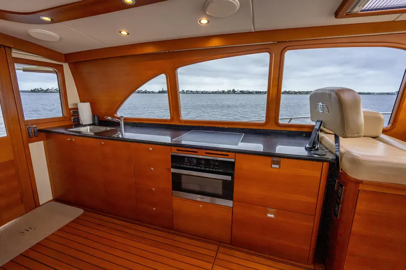 Slide: The Image of Luxurious 2018 Palm Beach Motor Yachts PB55 interior with sleek kitchen and scenic ocean view. - 22