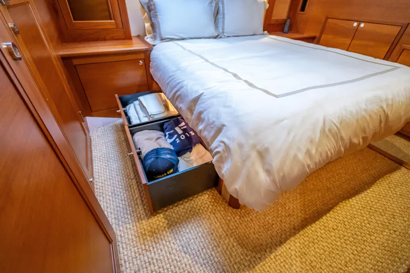 Slide: The Image of Luxurious cabin storage in 2018 Palm Beach Motor Yachts PB55, featuring under-bed drawers. - 36