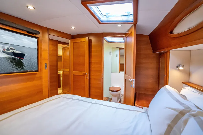 Slide: The Image of Luxurious 2018 Palm Beach Motor Yachts PB55 cabin interior with wood finish and skylight. - 38