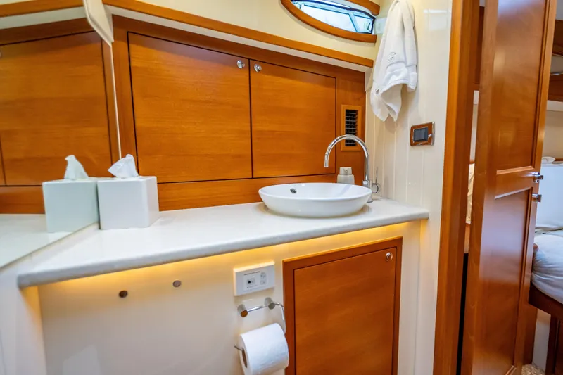 Slide: The Image of Luxurious bathroom interior of 2018 Palm Beach Motor Yachts PB55, featuring elegant wood cabinetry. - 40
