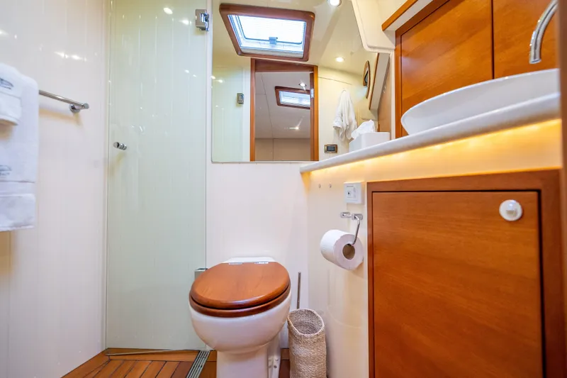 Slide: The Image of Luxurious bathroom in 2018 Palm Beach Motor Yachts PB55, featuring wood accents and modern fixtures. - 41