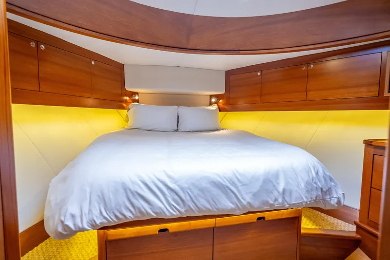 Slide: The Image of Luxurious 2018 Palm Beach Motor Yachts PB55 cabin with elegant wood finish and cozy bedding. - 44
