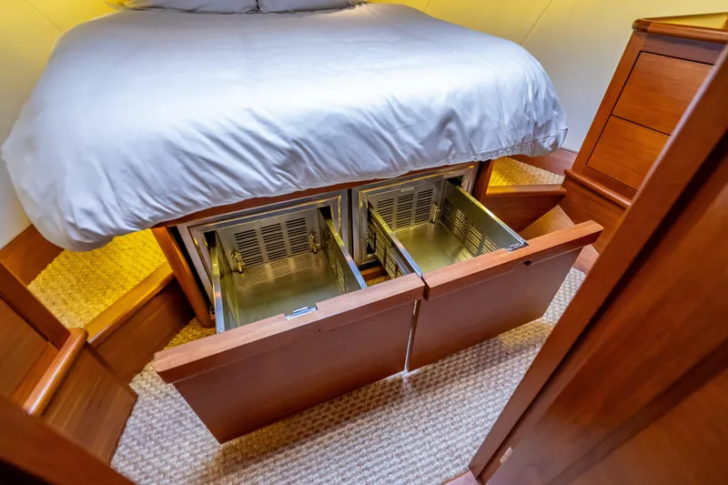 Slide: The Image of 2018 Palm Beach Motor Yachts PB55 bedroom with under-bed storage drawers open. - 46