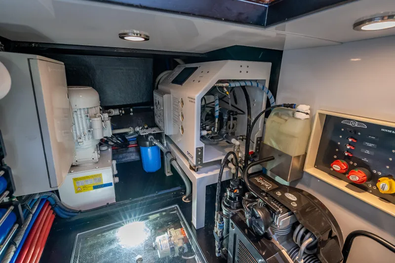 Slide: The Image of Engine room of 2018 Palm Beach Motor Yachts PB55, showcasing mechanical systems and controls. - 56