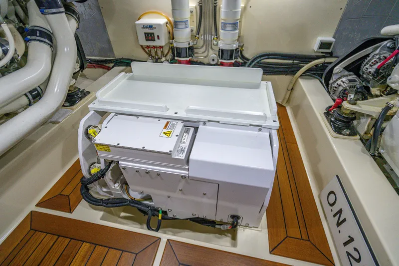 Slide: The Image of Engine room of 2018 Palm Beach Motor Yachts PB55 with mechanical components and wiring. - 59