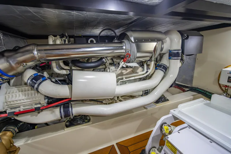 Slide: The Image of Engine room of 2018 Palm Beach Motor Yachts PB55, showcasing complex machinery and piping. - 60