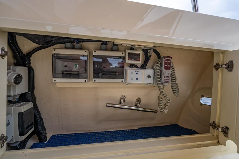 Slide: The Image of Electrical panel inside 2018 Palm Beach Motor Yachts PB55, showcasing wiring and controls. - 63