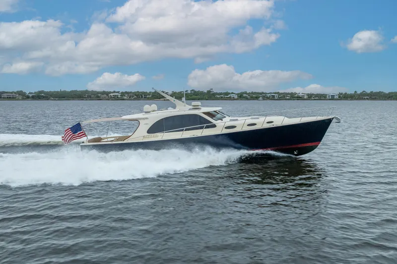 Slide: The Image of 2018 Palm Beach Motor Yachts PB55 cruising on water under a blue sky. - 67