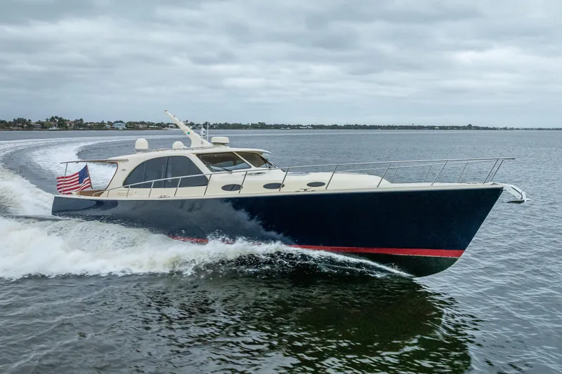 Slide: The Image of 2018 Palm Beach Motor Yachts PB55 cruising on water with American flag. - 68