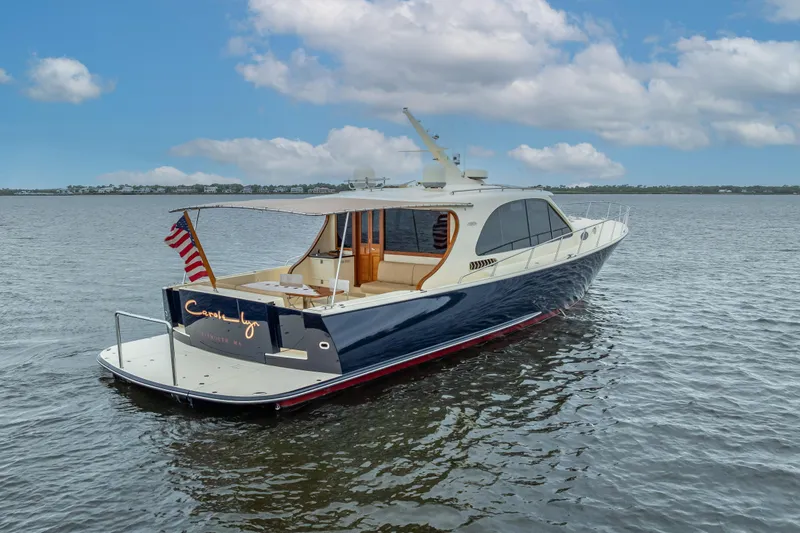 Slide: The Image of 2018 Palm Beach Motor Yachts PB55 on calm water, showcasing elegant design and luxury features. - 8